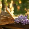 book of poetry and  lilac branch